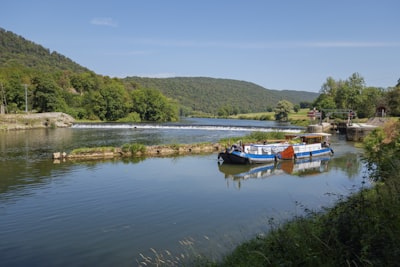 a couple of boats floating on top of a river