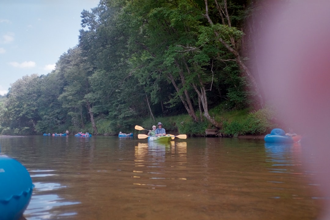 Person kayaking and tubing on a river